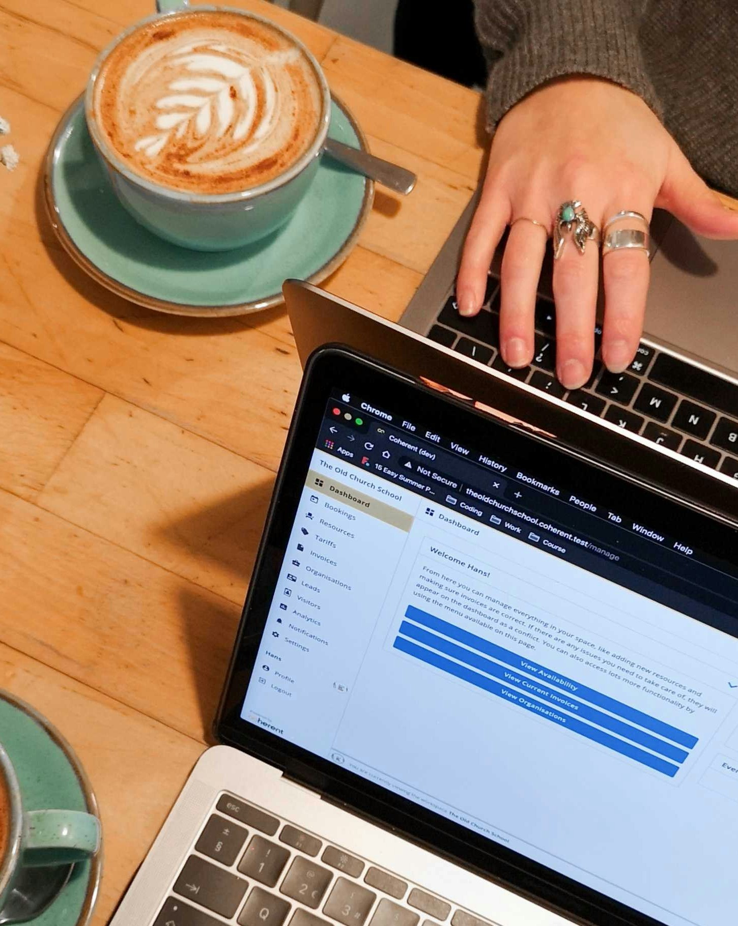 Person working on a laptop with coffee at a cafe table